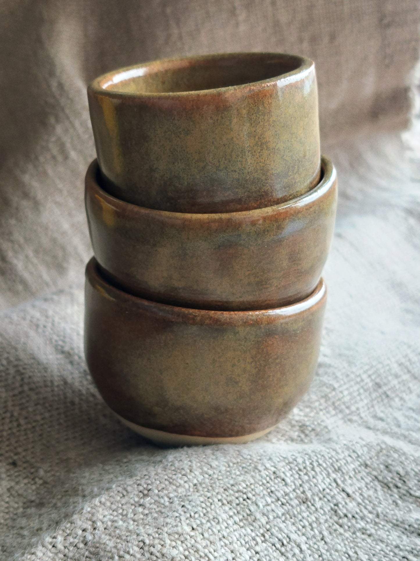 A stack of handmade ceramic cups
